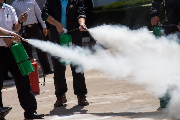 Group of Employees Learning how to use a fire extinguisher