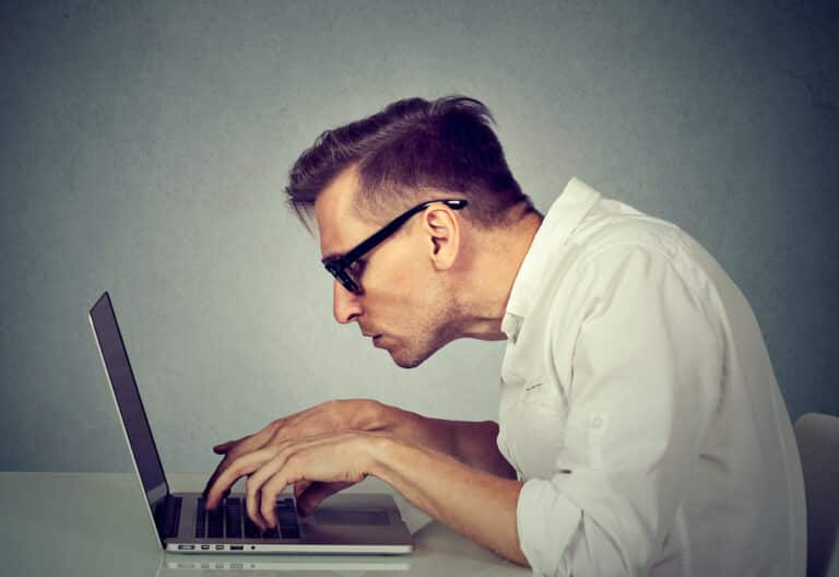 Man Slouched Over Computer