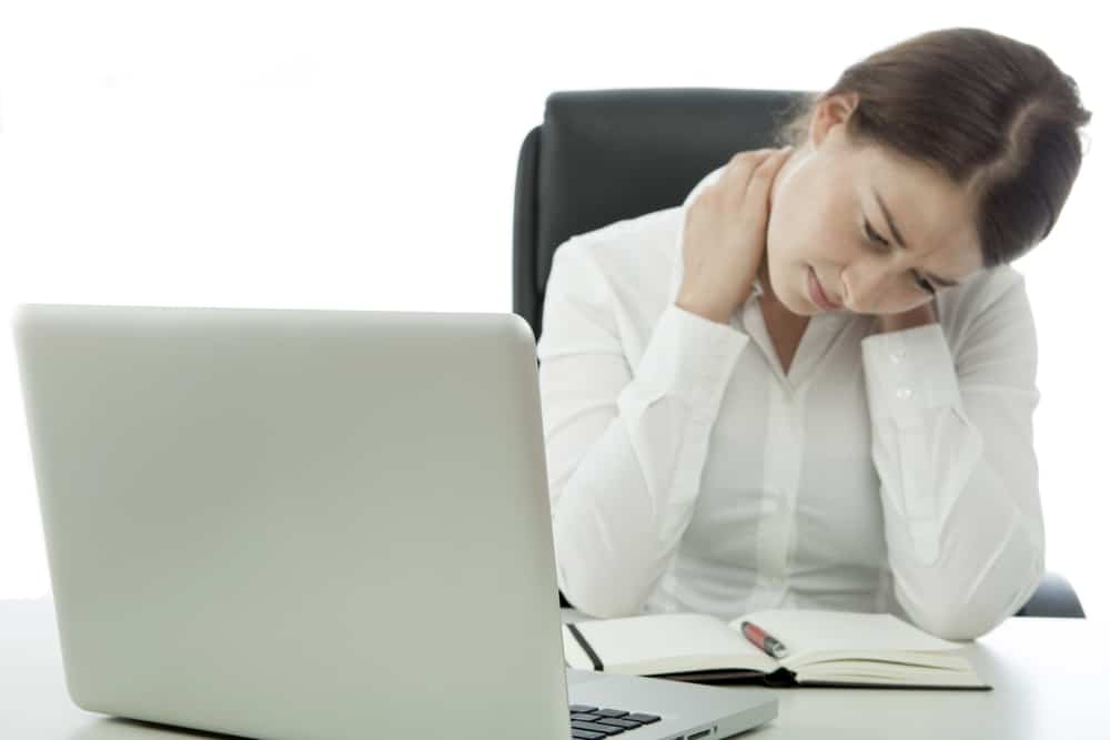 Woman Holding Her Neck From Pain at Desk