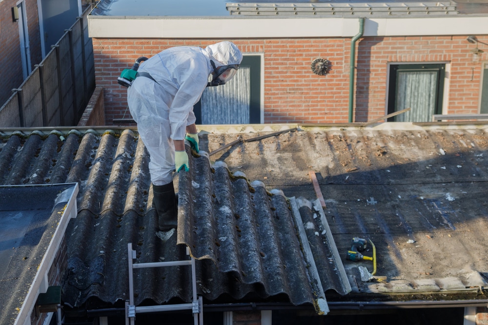 Worker Removing Asbestos From A Roof