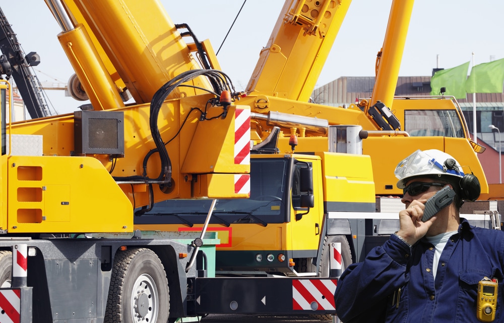 A crane operator standing by his mobile crane