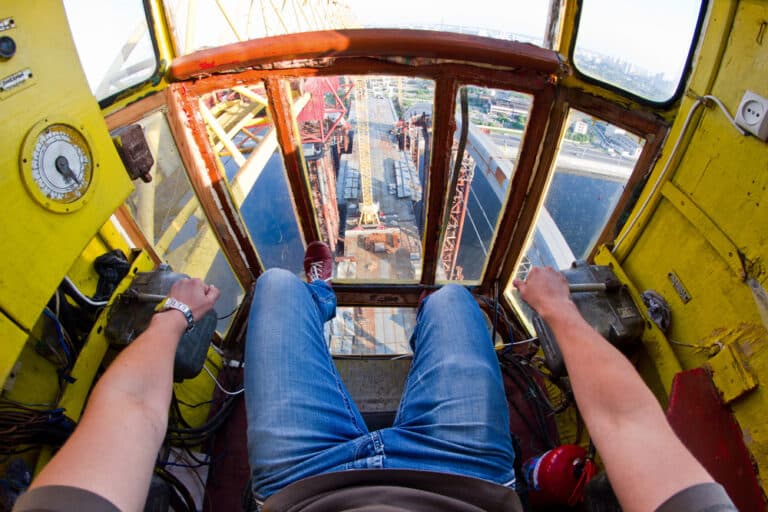 A crane operators feet on the floor of a crane