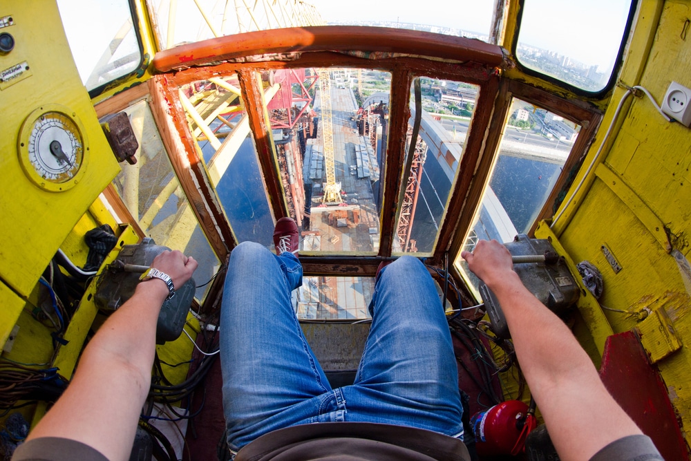 A crane operators feet on the floor of a crane