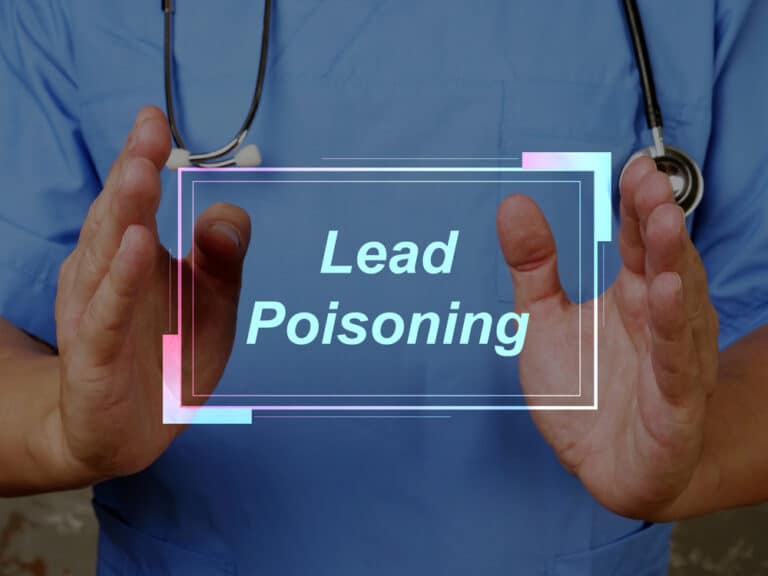 A doctor holding up a sign that says lead poisoning.