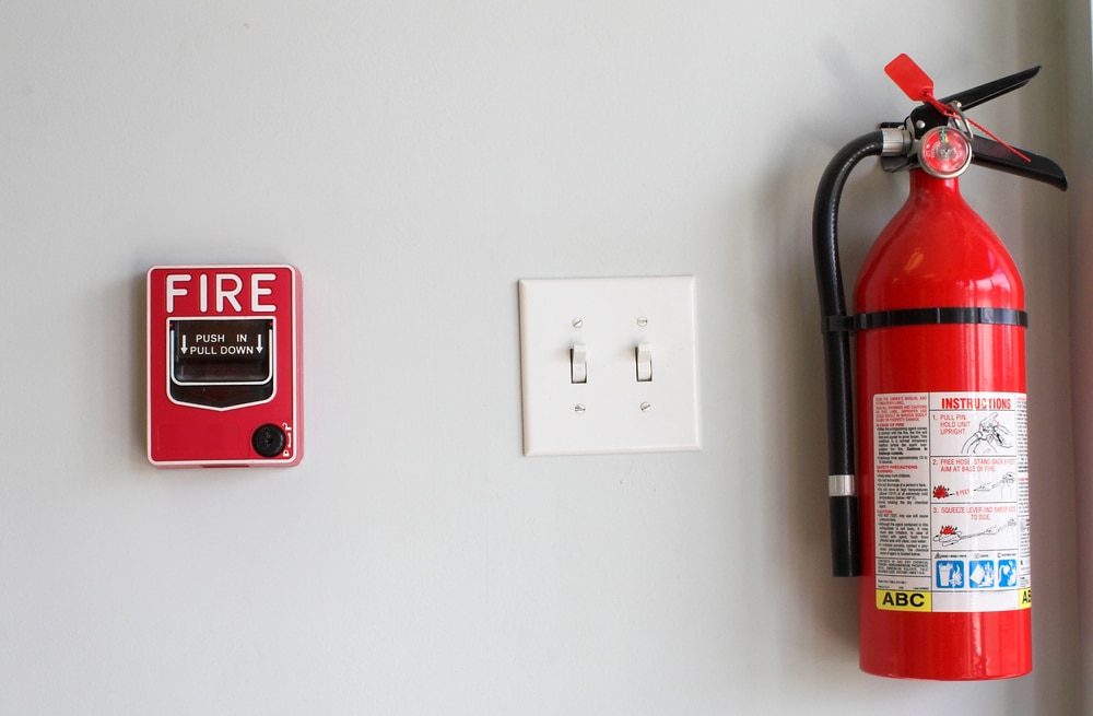A fire extinguisher and a fire extinguisher on a wall.