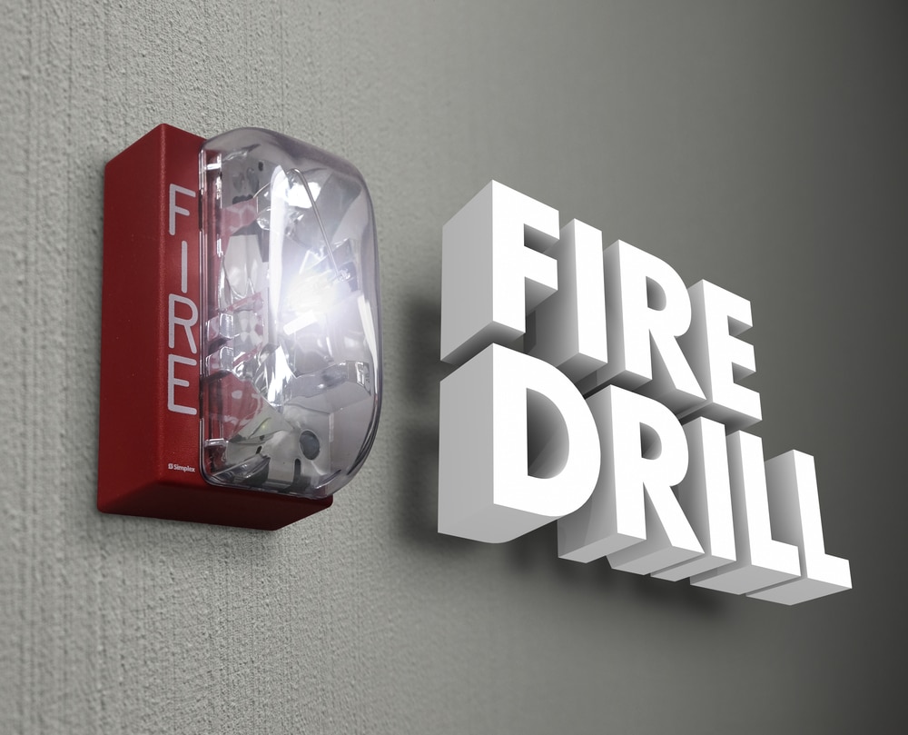 A fire drill sign on a wall.