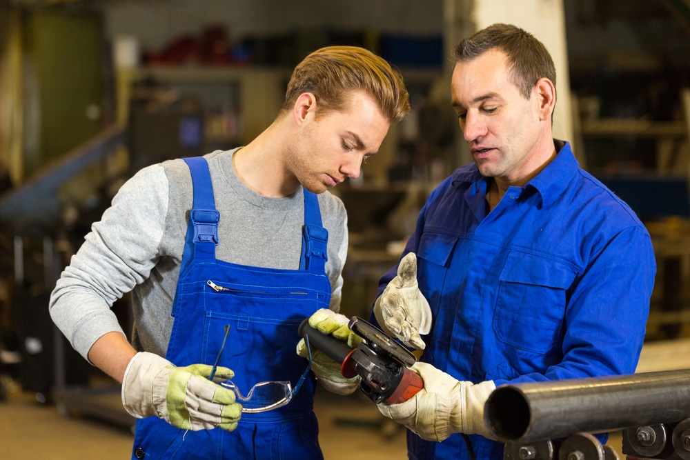 Two men working together in a workshop.