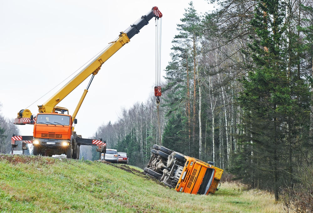 A crane is being used to lift a truck.