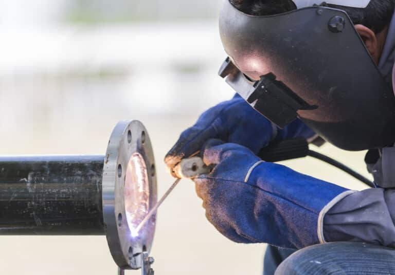 A welder working on a pipe.