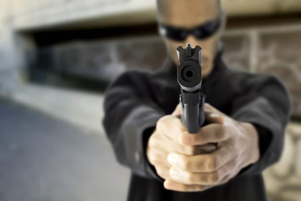 A man holding a gun in his hand.