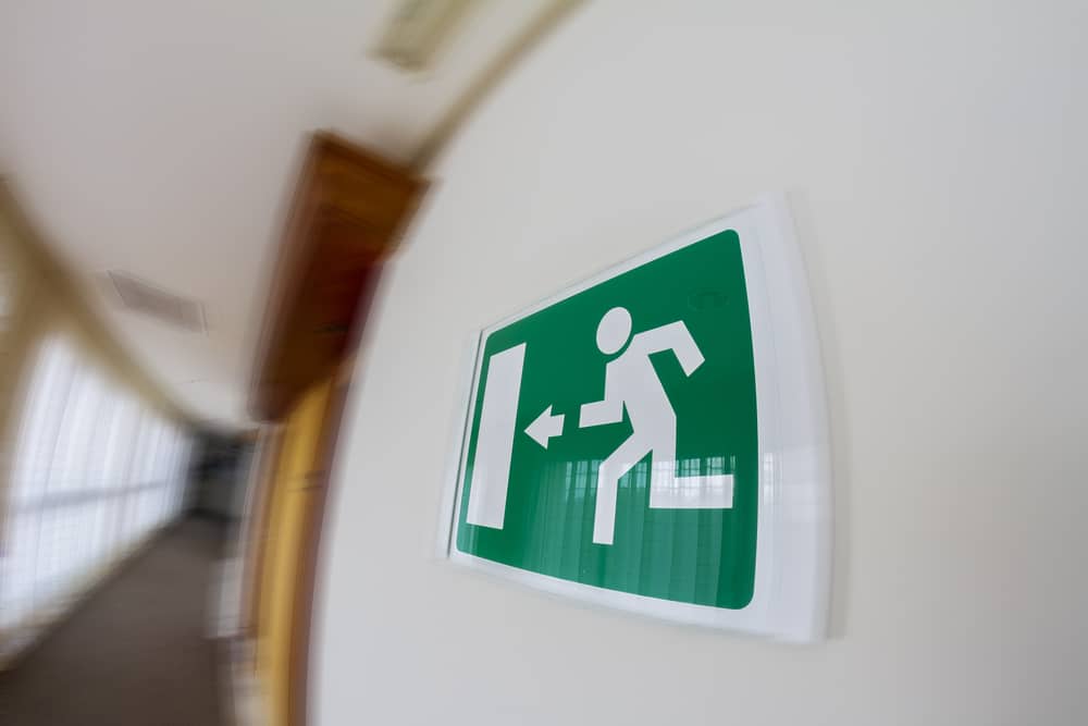 A blurred image of an exit sign in a hallway.