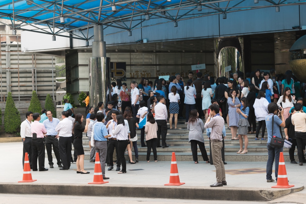 A group of people standing on steps after the fire drill has started