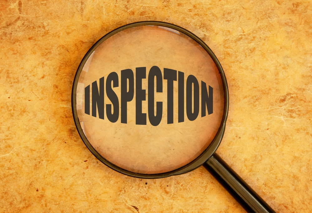 A magnifying glass with the word inspection on it.