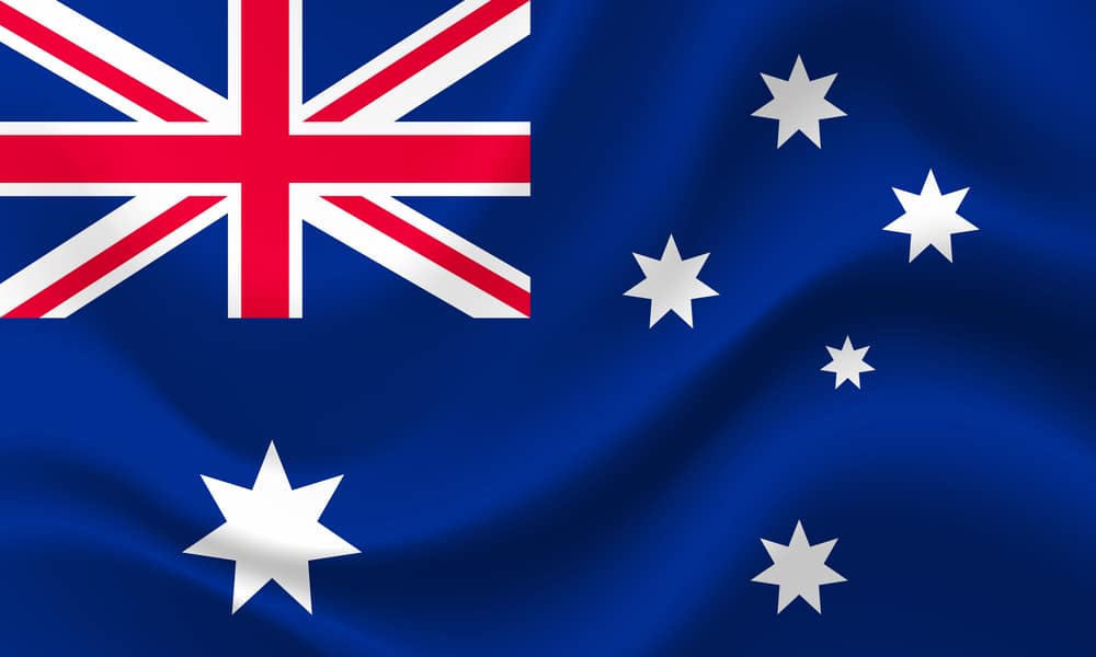 The australian flag is waving in the wind.