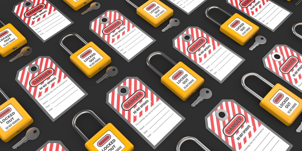 A set of yellow and red tags on a black background. These are used for lockout tagout procedure required by OSHA