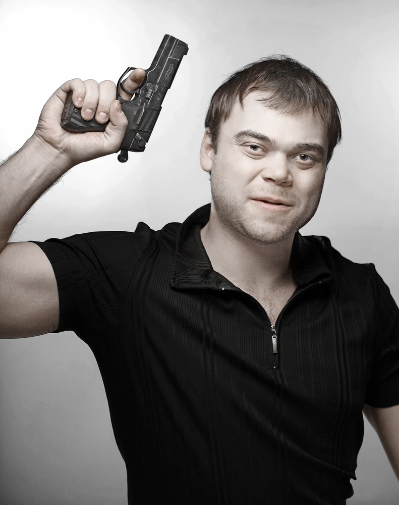 A man holding a gun in his hand.