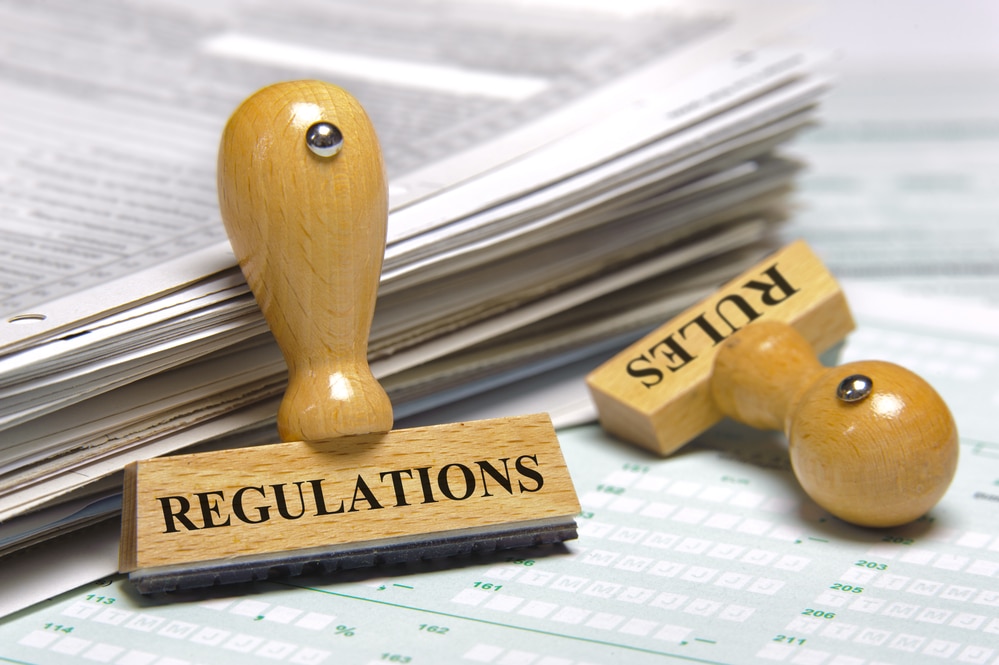 Two rubber stamps with the word "regulations" and "rules" on top of them.